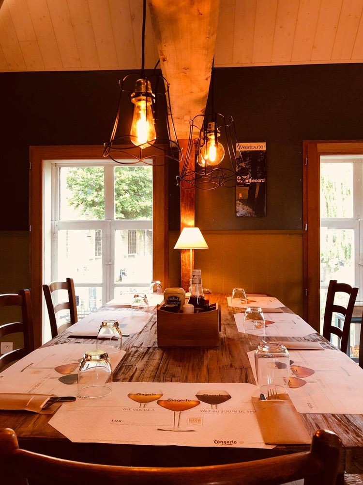 Long wooden table in front of the windows in the room upstairs