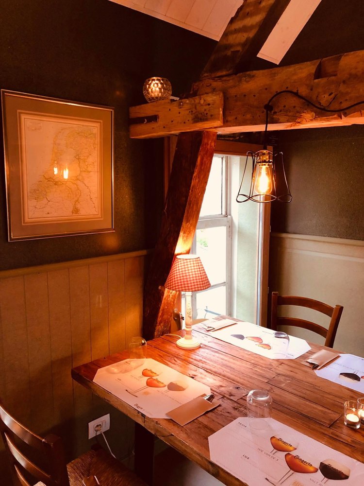 Corner of the room upstairs with an old map and exposed beams
